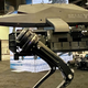 A robot dog with a rifle strapped to its body